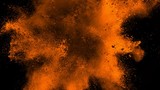 Super slowmotion shot of golden powder explosion isolated on black background.