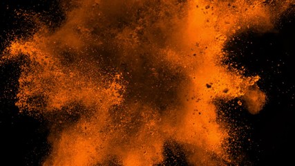 Super slowmotion shot of golden powder explosion isolated on black background.
