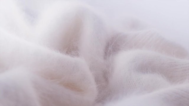 Soft wool background. Alpaca wool mohair clothes texture closeup. Natural cashmere fluffy merino wool. Woolen fabric. Rotated. 4K UHD video footage. 3840X2160