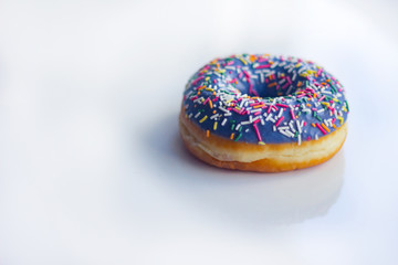 sweet Donut with icing and color dusting, on a white background