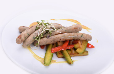 Munich sausages with grilled vegetables on a white plate