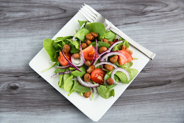 healthy dinner salad bowl of garden greens and bean protein