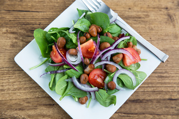 healthy dinner salad bowl of garden greens and bean protein