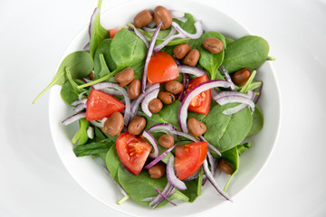 healthy dinner salad bowl of garden greens and bean protein
