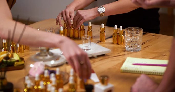 Close up of perfumers selecting essential oils