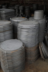 Stocks Of Unfinished Gray Manhole Cast Lids Close Up