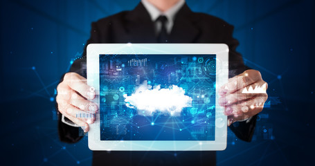 Hand holding tablet with cloud technology and dark concept

