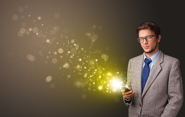 Person using phone with gold sparkling concept
