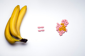 Bananas equal to vitamin pills. Conceptual image of healthy lifestyle