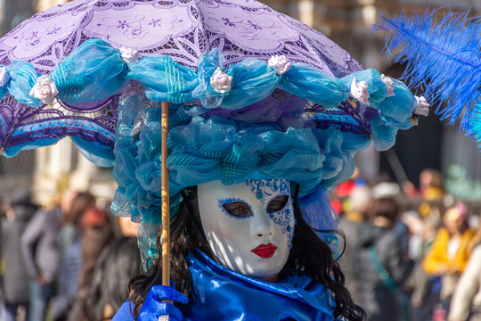 Italy, Venice,  carnival,  2019,  people with beautiful masks walk around Piazza San Marco, in the streets and canals of the city, posing for photographers and tourists, with colorful clothes.