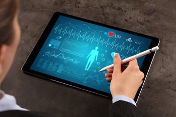 Business woman making healthy analysis on tablet
