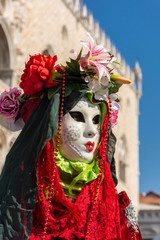 Italy, Venice,  carnival,  2019,  people with beautiful masks walk around Piazza San Marco, in the streets and canals of the city, posing for photographers and tourists, with colorful clothes.