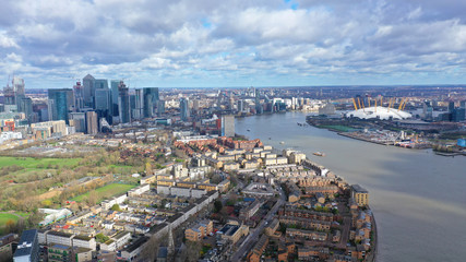 Aerial bird's eye view photo taken by drone of Canary Wharf skyline as seen from river Thames with...