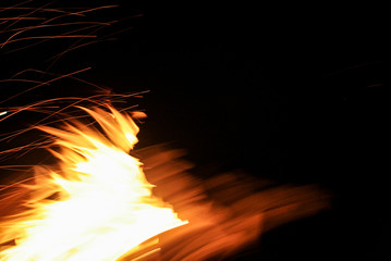 Fire with sparks on a black background. Flame. Bonfire Summer night