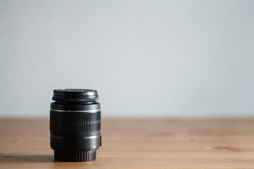 the lens on a wooden table a solid background