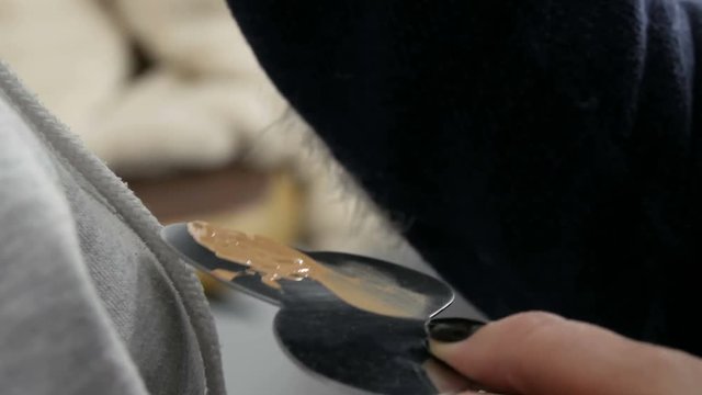 A professional makeup artist uses a make-up concealer. Makeup artist hands stir the foundation