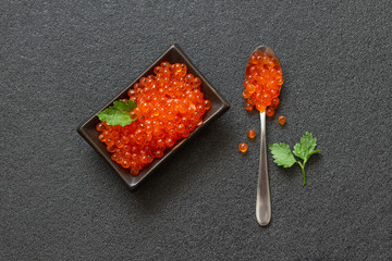 Red salmon caviar on dark background