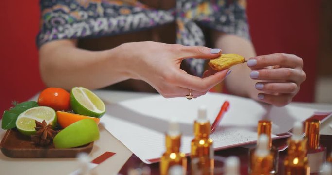 Close up of perfumer picking dried pear