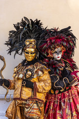 Italy, Venice, carnival 2019, typical masks, beautiful clothes, posing for photographers and tourists.