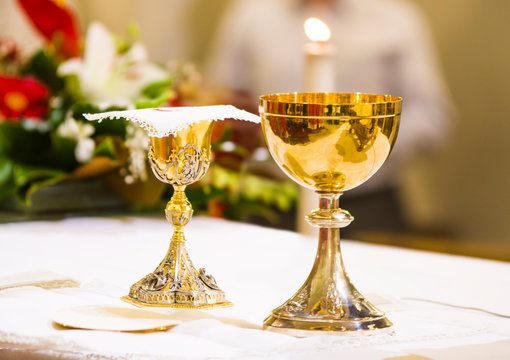 cup with wine and ciborium with host on the altar of the holy mass