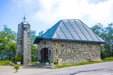 mountain church with stone bell tower