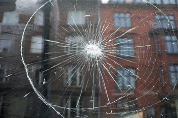 House reflected in broken window
