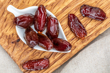 Close-up of juicy dates (fruit). On wood and rustic appearance.