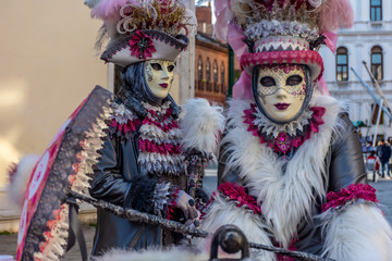 Italy, Venice, carnival 2019, typical masks, beautiful clothes, posing for photographers and tourists.