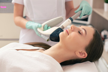 Close up of smiling woman undergoing non-invasive procedure