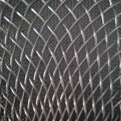 Microphone grid. Background of twisted steel wire. Patterned texture of metal. Macro shooting with...