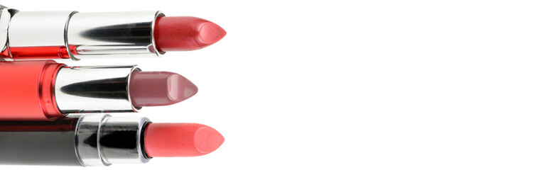 Lipsticks isolated on white background. Free space for text. Wide photo.