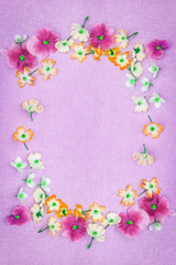 Beautiful pansies and roses in pink on the farbic background