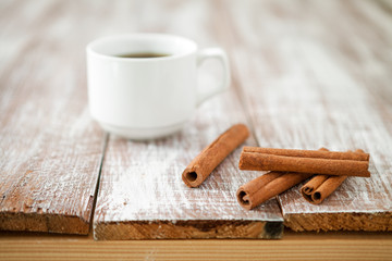 Cup of coffee with brown sugar on a wooden table.