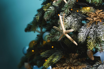Christmas decoration in gold and blue colors. New year decoration in nautical style. Seashells,...