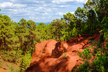Roussillon ocher deposit: Beautiful green pines and orange rocks.