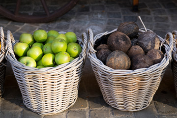woven baskets with green apples and coconuts
