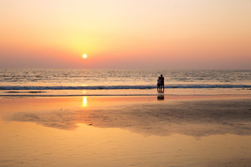 Couple and  orange sunset .  South India.