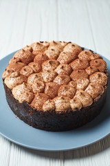 Vanilla cheesecake with milk chocolate cream and cocoa