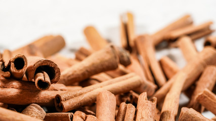 Pile of organic cinnamon bark, selective focus photo - only few sticks in focus