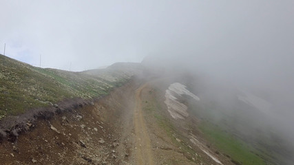 Road in clouds high in the mountains