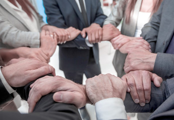 background image of business team folded their hands forming a circle