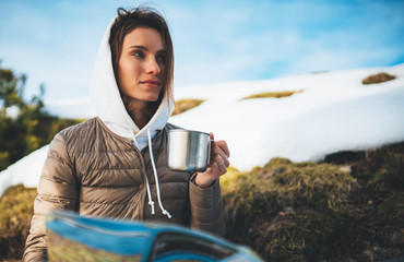 people planning trip in snow mountain, girl hold in hands cup of drinks, relax tourist look on map,...