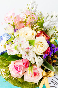 Photo of romantic bouquet of pink roses, lilies, green leaves.