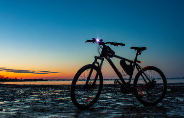 Fototapeta na wymiar bicycle on the beach at sunset