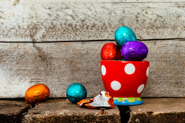 Chocolate easter eggs in three colorful egg cups