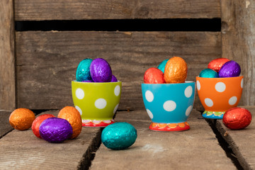 Chocolate easter eggs in three colorful egg cups