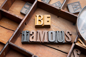 Be Famous in wooden typeset letters. 