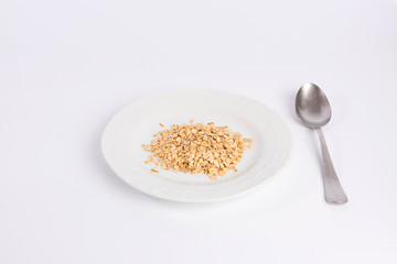 pile of oatmeal on a plate isolated on white background