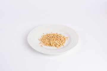 pile of oatmeal on a plate isolated on white background