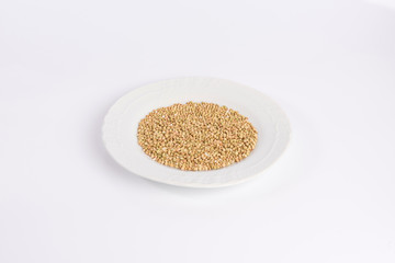 green buckwheat on a plate isolated on white background